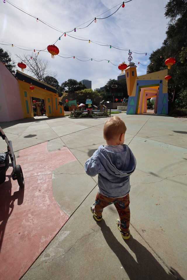 Young Child Explores Colorful Festival Plaza
