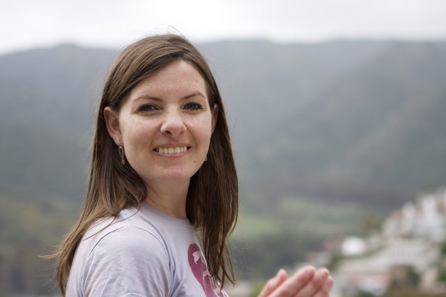 Smiling Woman Overlooking a Mountain Village