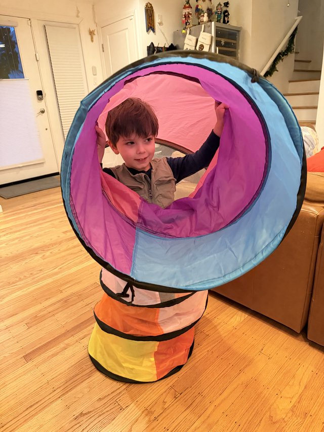 Child Playing in Colorful Pop-Up Tunnel Toy