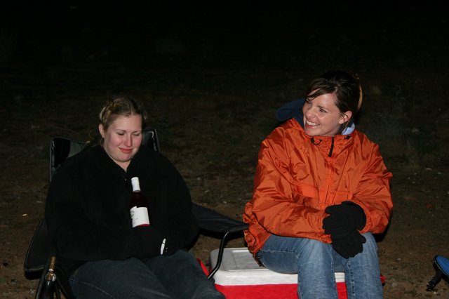 Two Women Laughing at a Nighttime Campsite