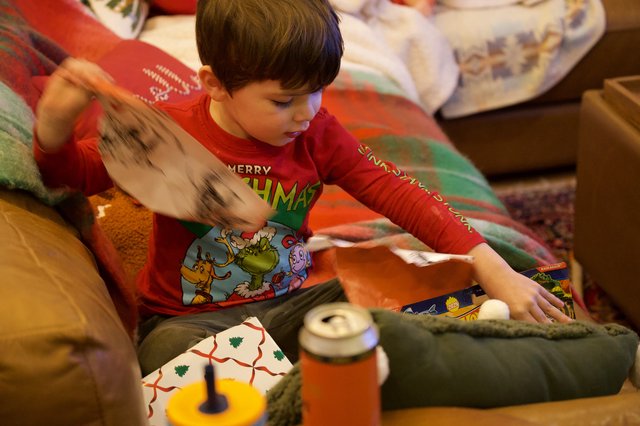 Child Opening Christmas Presents on Christmas Morning