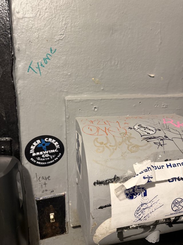 Graffiti and Stickers in Urban Bathroom Corner