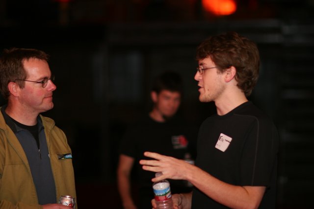 Two Men Enjoying Drinks and Conversation at BarCamp 2006