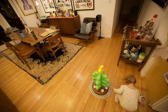 Child Playing with Toy Palm Tree in Mid-Century Modern Living Room