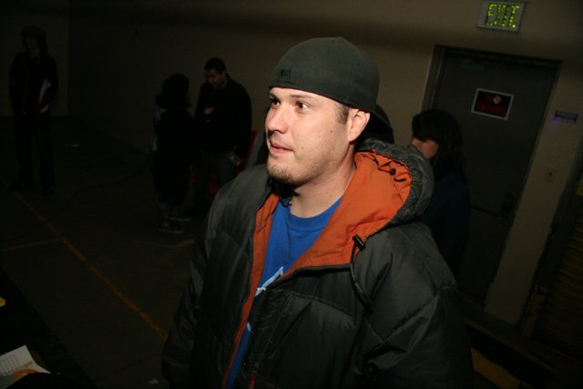Fashionable Man in Black Jacket and Blue Hat