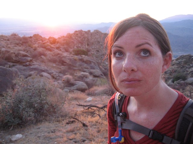 Hiker Pauses at Sunset on Rocky Desert Trail