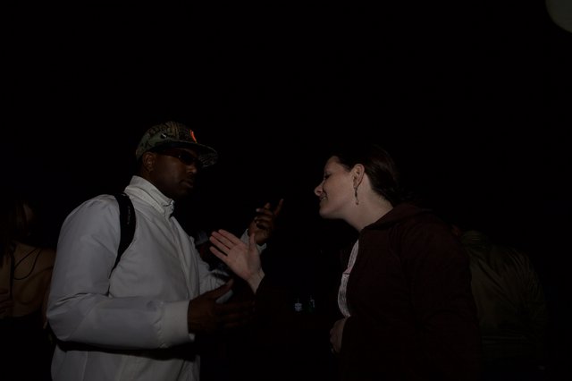 Animated Conversation Between Two People at Night Event