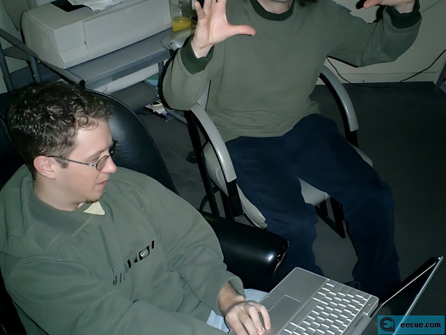 Green Sweatered Man Working on Laptop