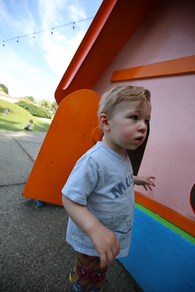 Young Boy at Colorful Playground Structure in Park