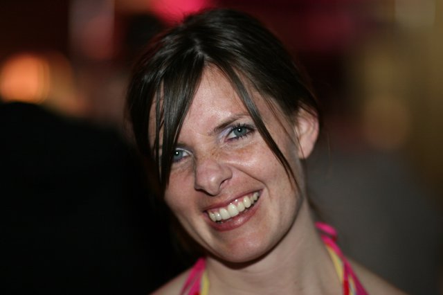 Radiant Smile at a Vibrant Evening Gathering