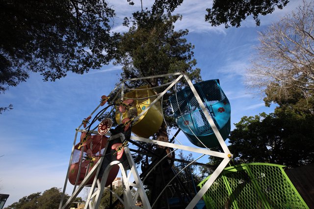 Children Enjoying Colorful Ferris Wheel at Dusk