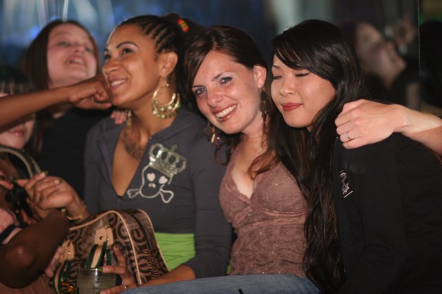 Three Friends Celebrating at a Nightclub Together