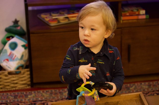 Toddler Playing with Toys on Christmas Eve