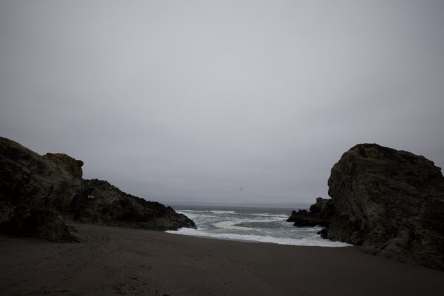 Moody Coastal Cove Between Ancient Rocky Sentinels