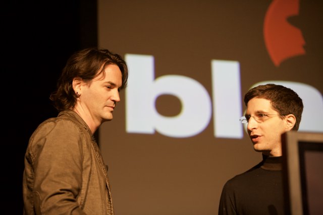 Two Men Presenting in Front of a Screen
