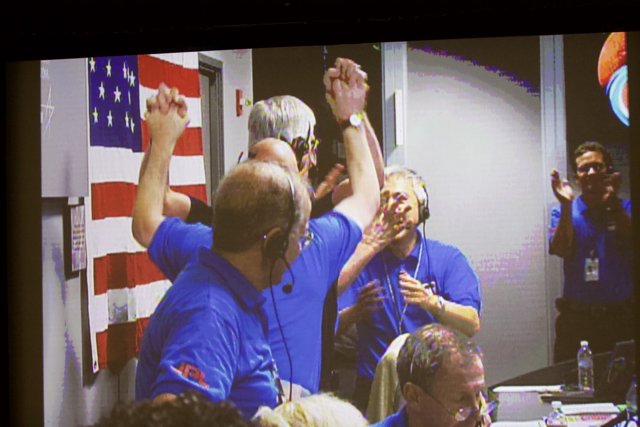 Blue-clad Group Proudly Waves American Flag