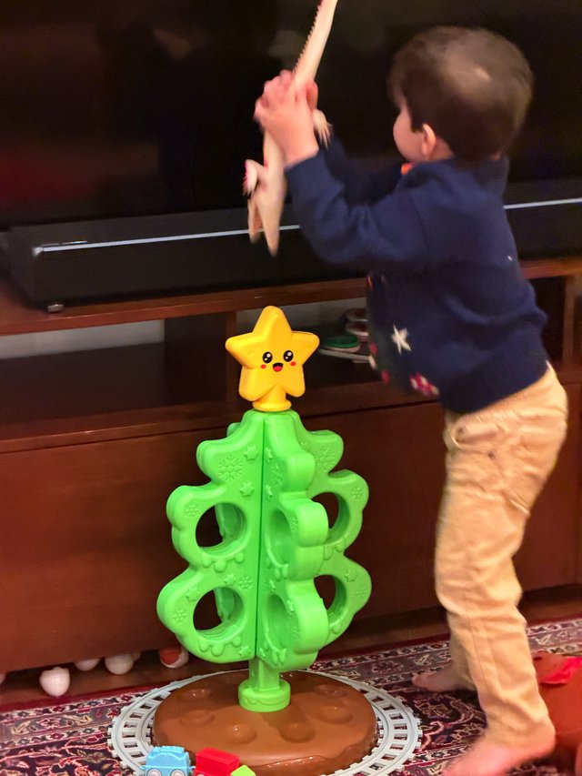 Toddler Playing Interactive Christmas Tree Game at Home