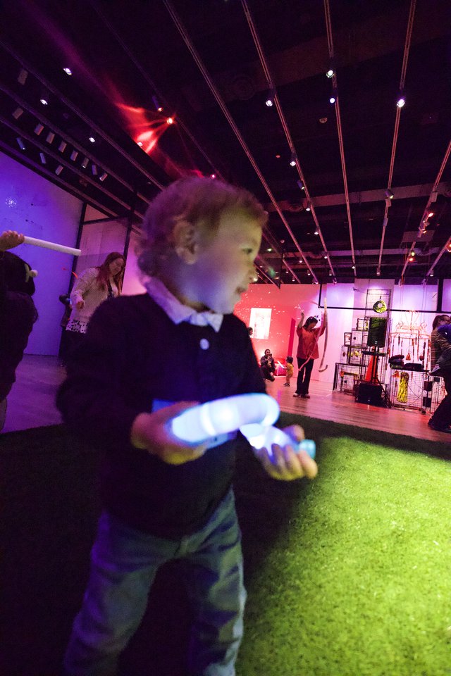 Child Dancing with Glowing Toy at Baby Rave Event