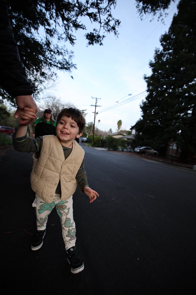 Joyful Child Walking Hand-in-Hand at Dusk