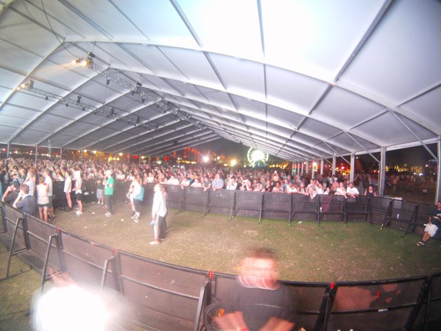 Massive Crowd Gathers for Concert in Outdoor Tent