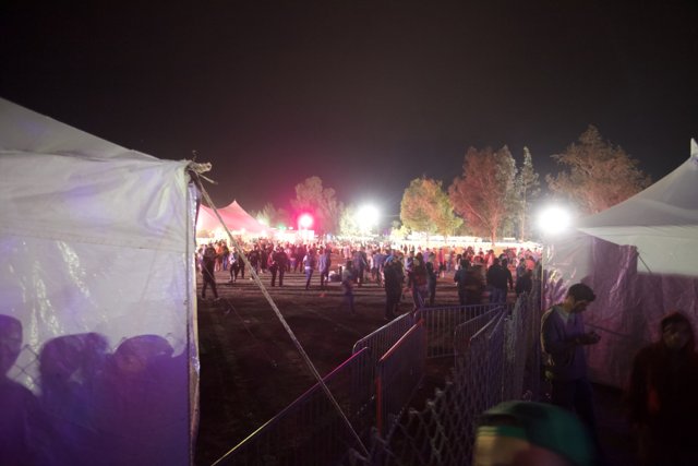 Nighttime Crowd in a Festival Tent