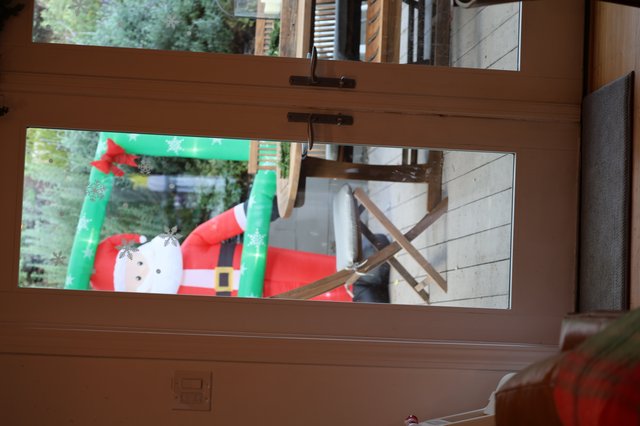 Christmas Snowman Decoration Through Patio Door View