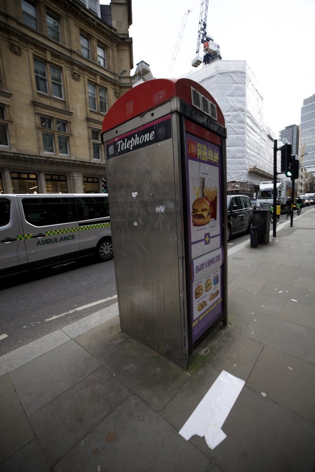 Traditional Red Telephone Box with McDonald's Advertisement in London