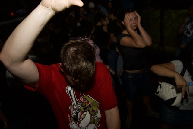Red Shirted Man Dancing in Nightclub Crowd
