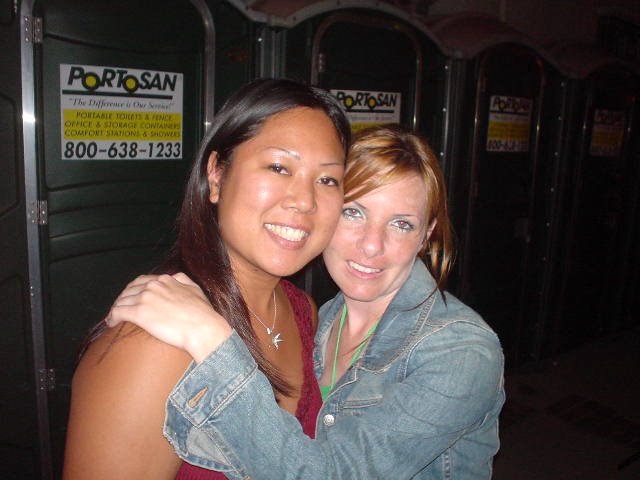 Two Friends Smiling Together at Outdoor Event