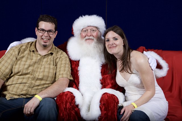 Holiday Couple Poses with Santa Claus Portrait