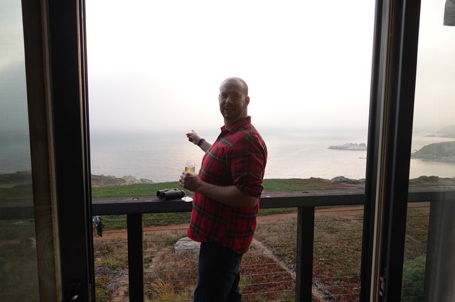 Man enjoying coastal view from balcony