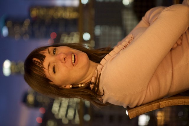 Penelope Smiling Against a City Nightscape