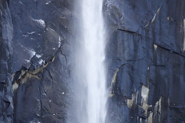 Cascading Waterfall Through Dramatic Granite Cliffs in Winter