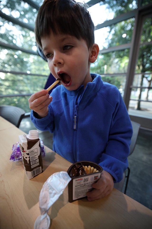 Young Boy Enjoying Nutella and Breadsticks Snack