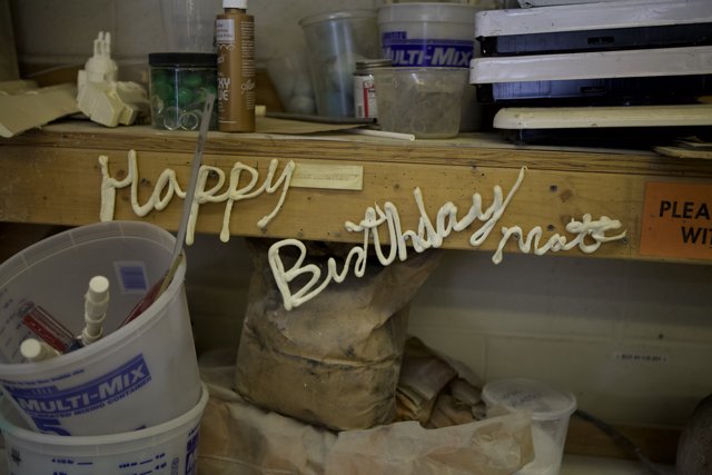Birthday Sign and Paint Bucket on Wooden Shelf