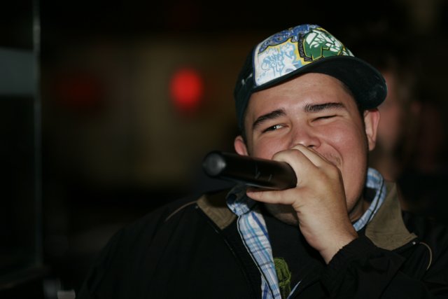 Entertainer with Baseball Cap and Microphone