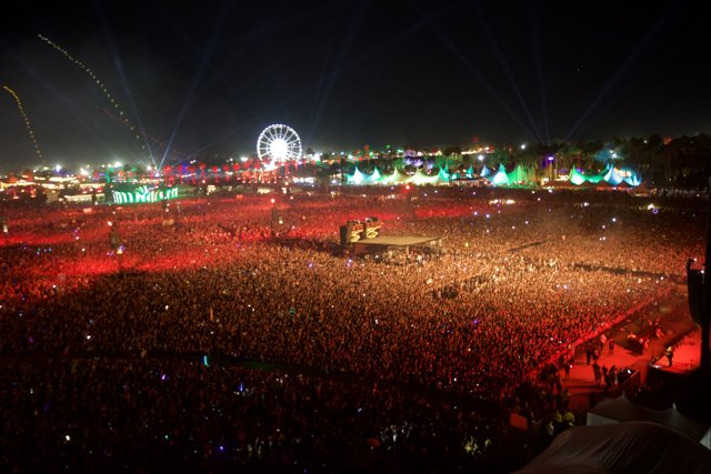 Lights, Music, Action Caption: The electric atmosphere at Coachella's night time concert is enough to leave you breathless. With an audience of thousands, the city skyline and fireworks lighting up the sky, the energy is unmatched.