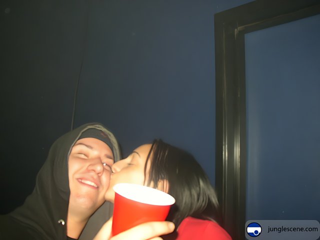 A Romantic Kiss with a Red Cup