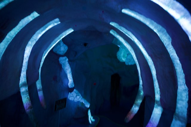 Immersive Blue Spiral Light Installation with Silhouettes