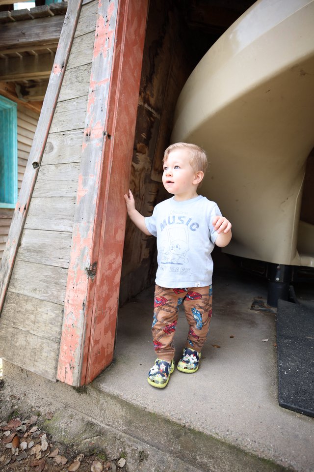Young Boy Exploring Vintage Doorway with Curiosity