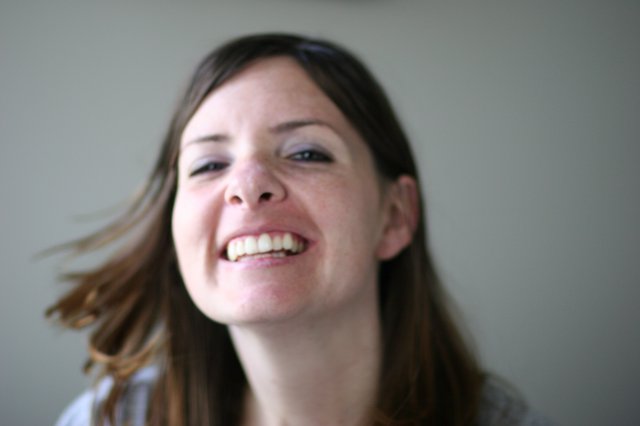Joyful Woman Laughing with Hair in Motion