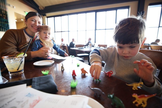Family Mealtime with Dinosaur Play at Restaurant