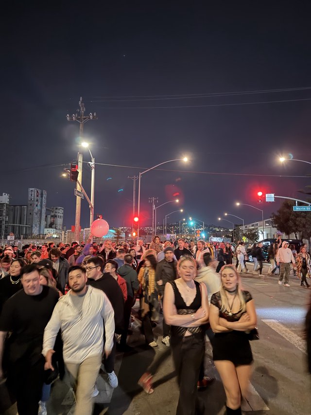 Night Crowd at Urban Street Intersection with Red Traffic Lights
