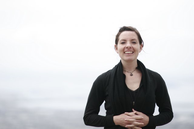 Smiling Woman Portrait Against Misty Ocean Backdrop