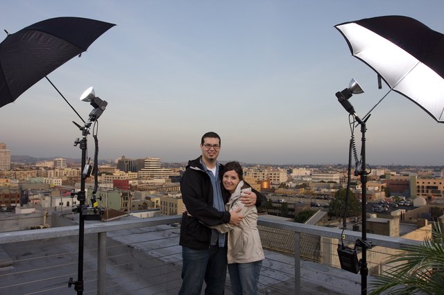 Couple Embraces on Rooftop Overlooking Los Angeles Skyline