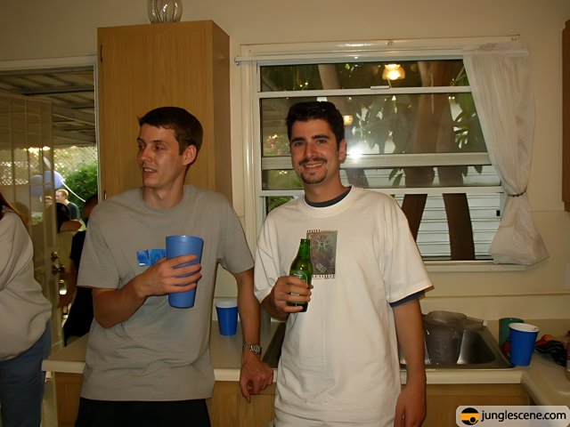 Two Men Enjoying Drinks in the Kitchen