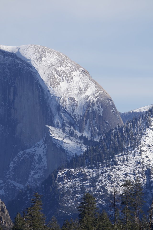 Half Dome's Majestic Snow-Covered Granite Face in Winter