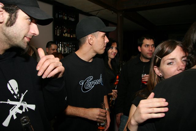 Friends Socializing at a Dimly Lit Nightclub Bar