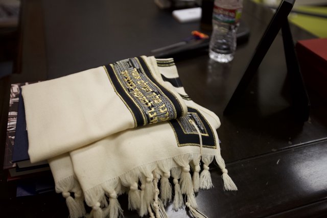 Elegant White Scarf with Gold and Black Writing