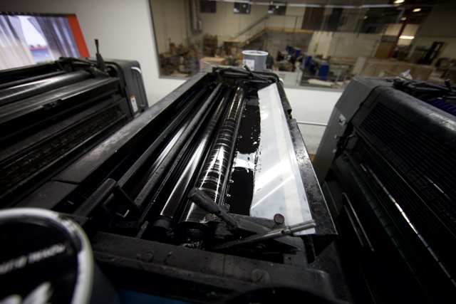 Large Printer in a Room Full of Machines